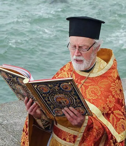 Priest reading the Holy Bible
